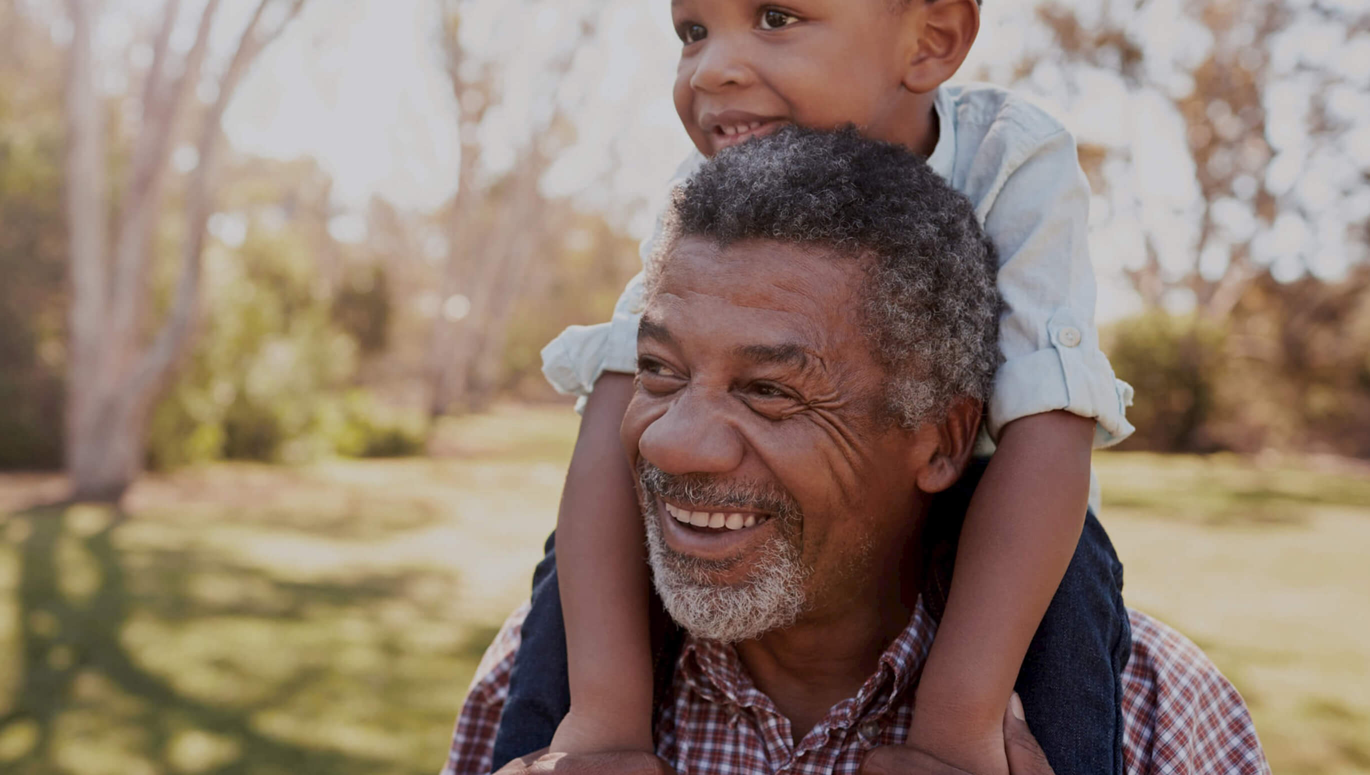 Grandfather carrying his grandson