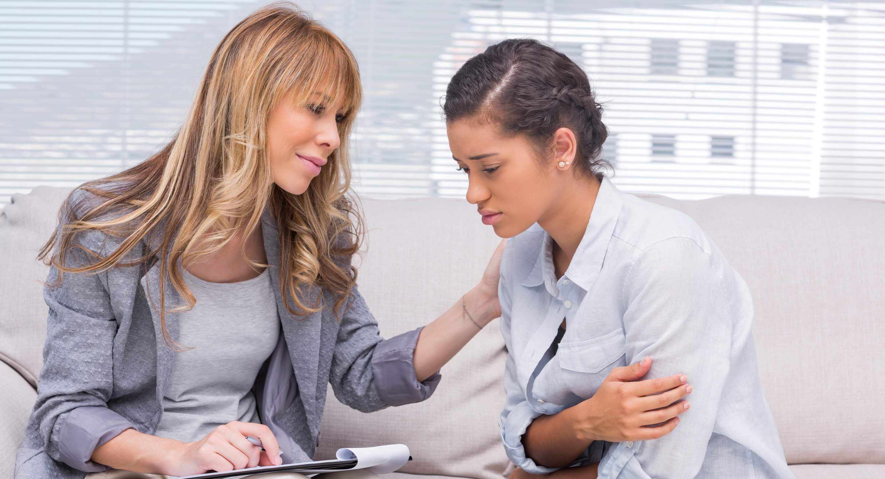 Female clinician and teen girl meeting