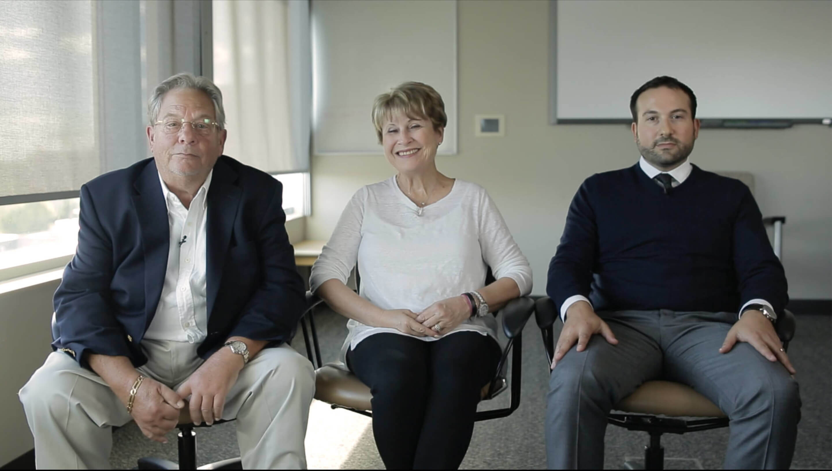 Three members of the Lewin family sitting in a row