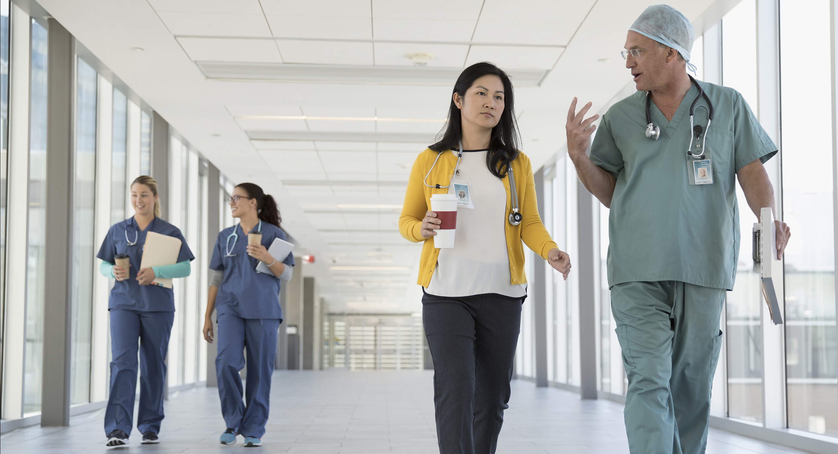 Doctors and medical professionals walking in hallway