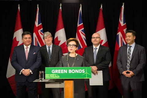 CEO, Catherine Zahn speaking in front of a podium with the sign 