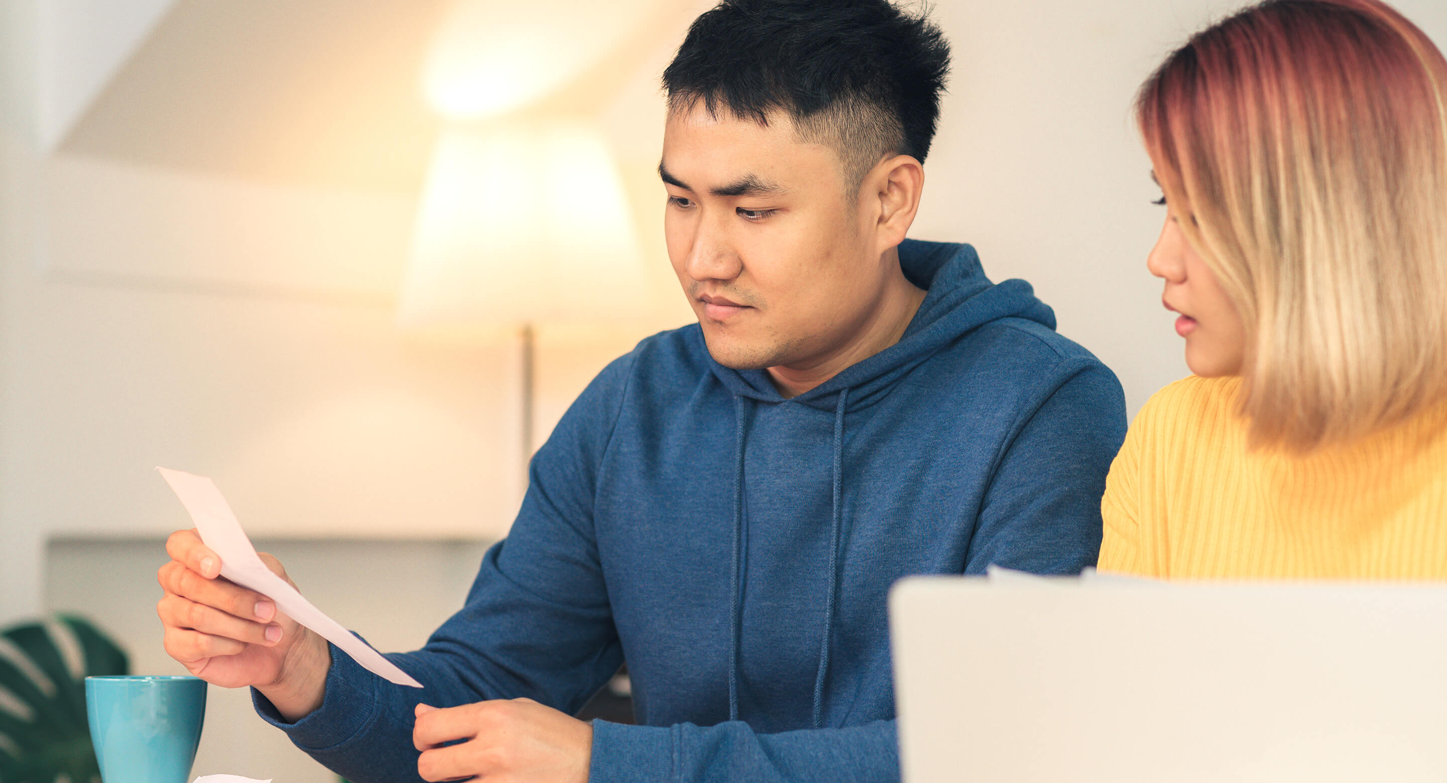An Asian couple worried about paying bills.