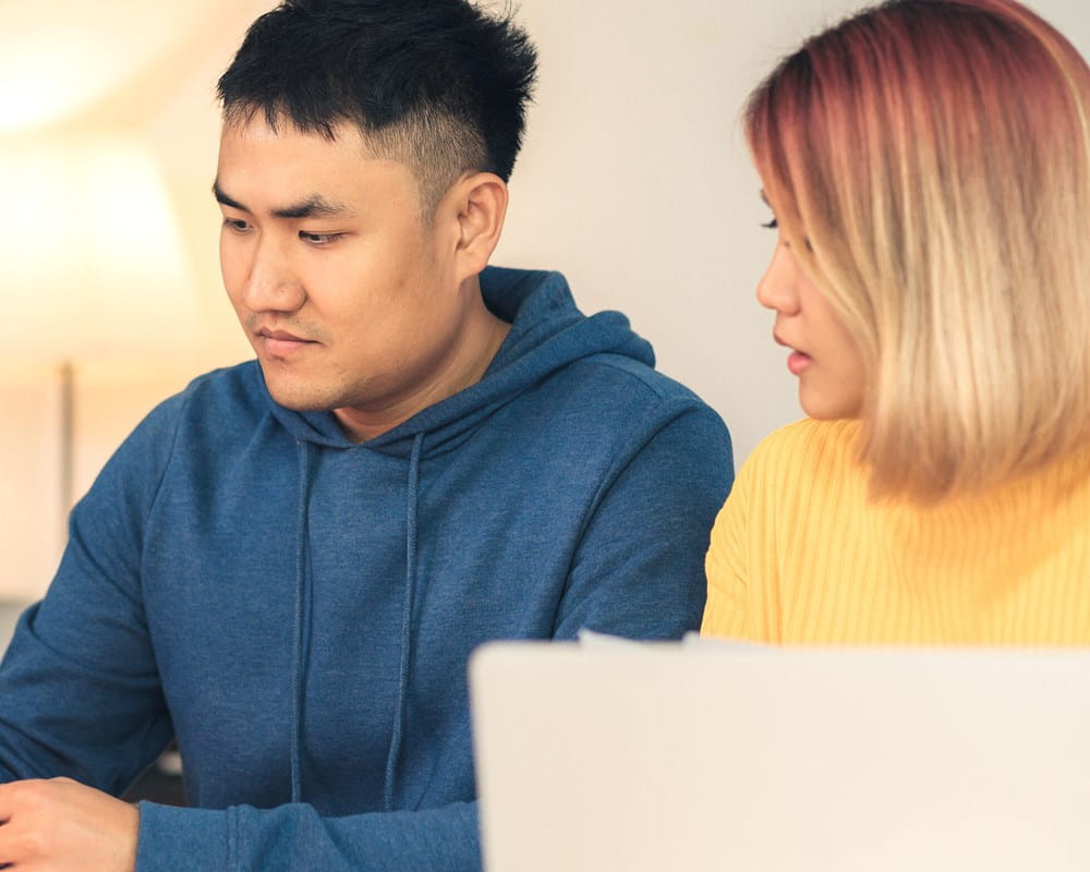 An Asian couple worried about paying bills.