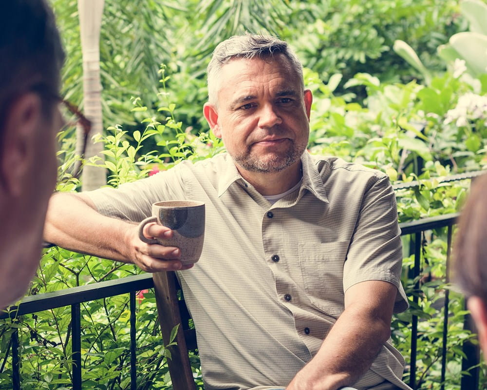 Men having coffee and having a chat.