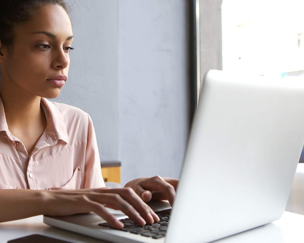 A young woman researches mental health on a computer
