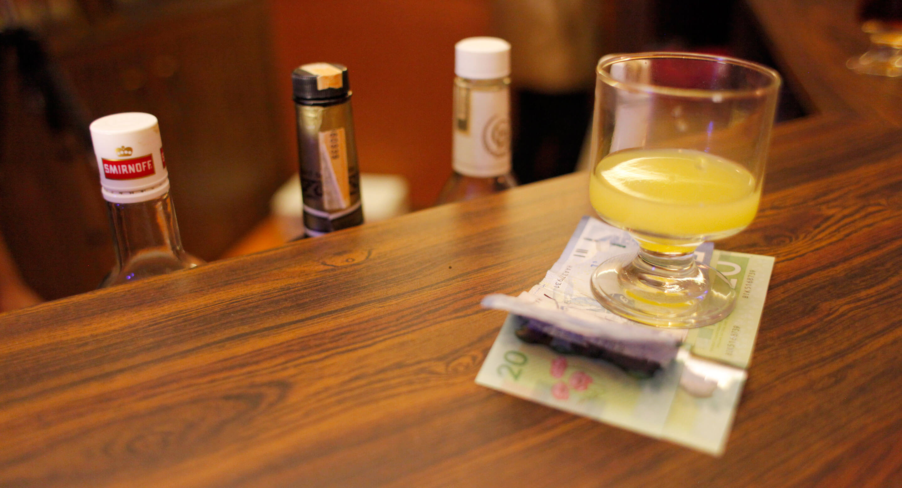 Glass with drink in bar counter