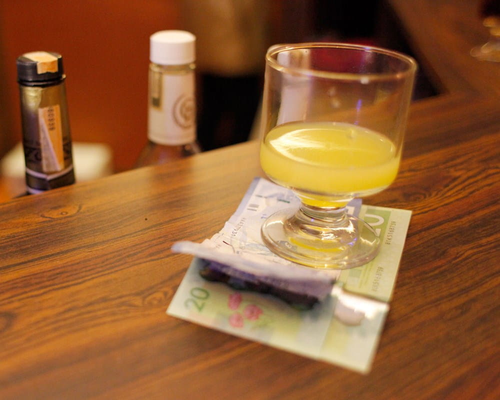 Glass with drink in bar counter