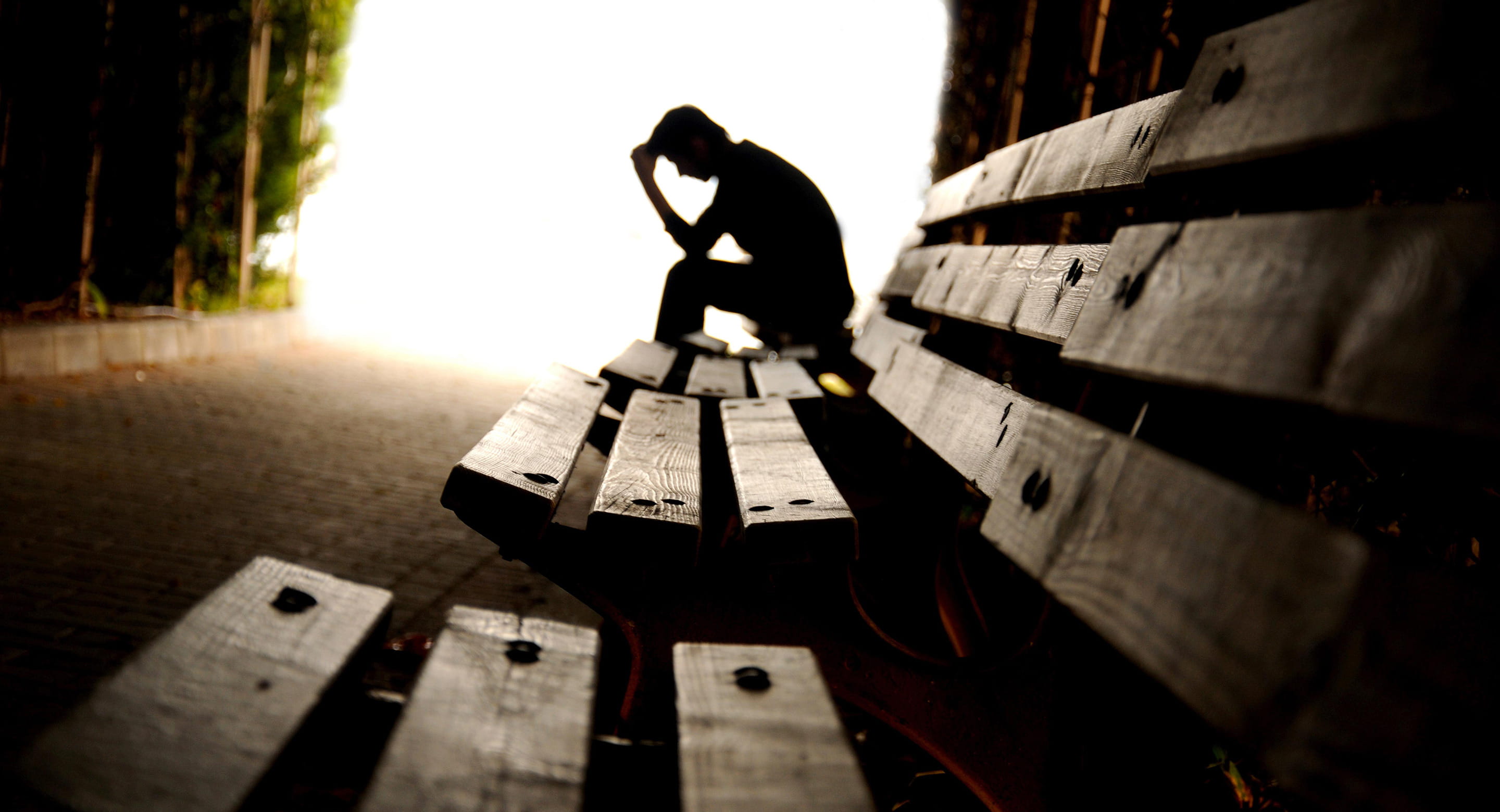 Person sitting along looking like they are in distress