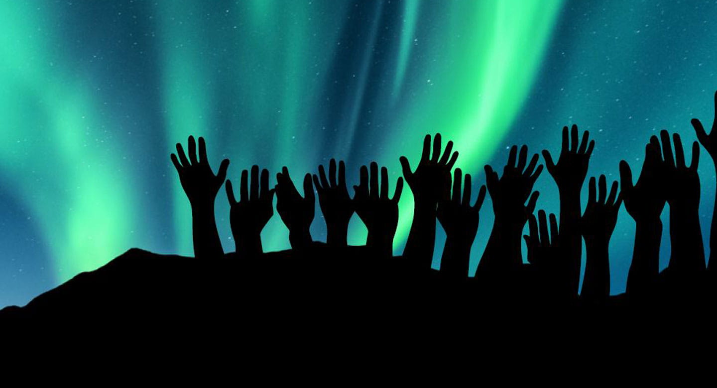 Hands outline over aurora borealis sky