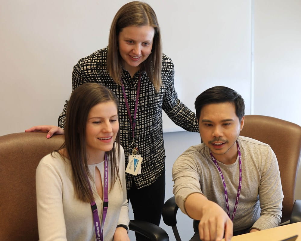 Nurses around computer