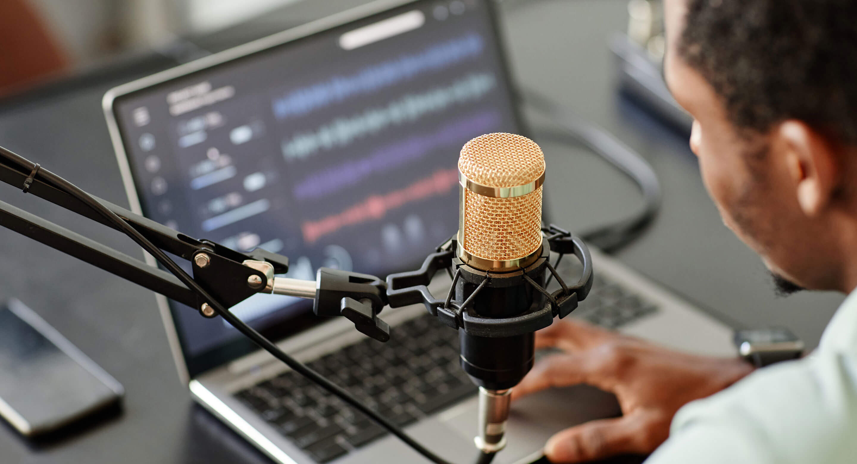 Man in front of computer and microphone