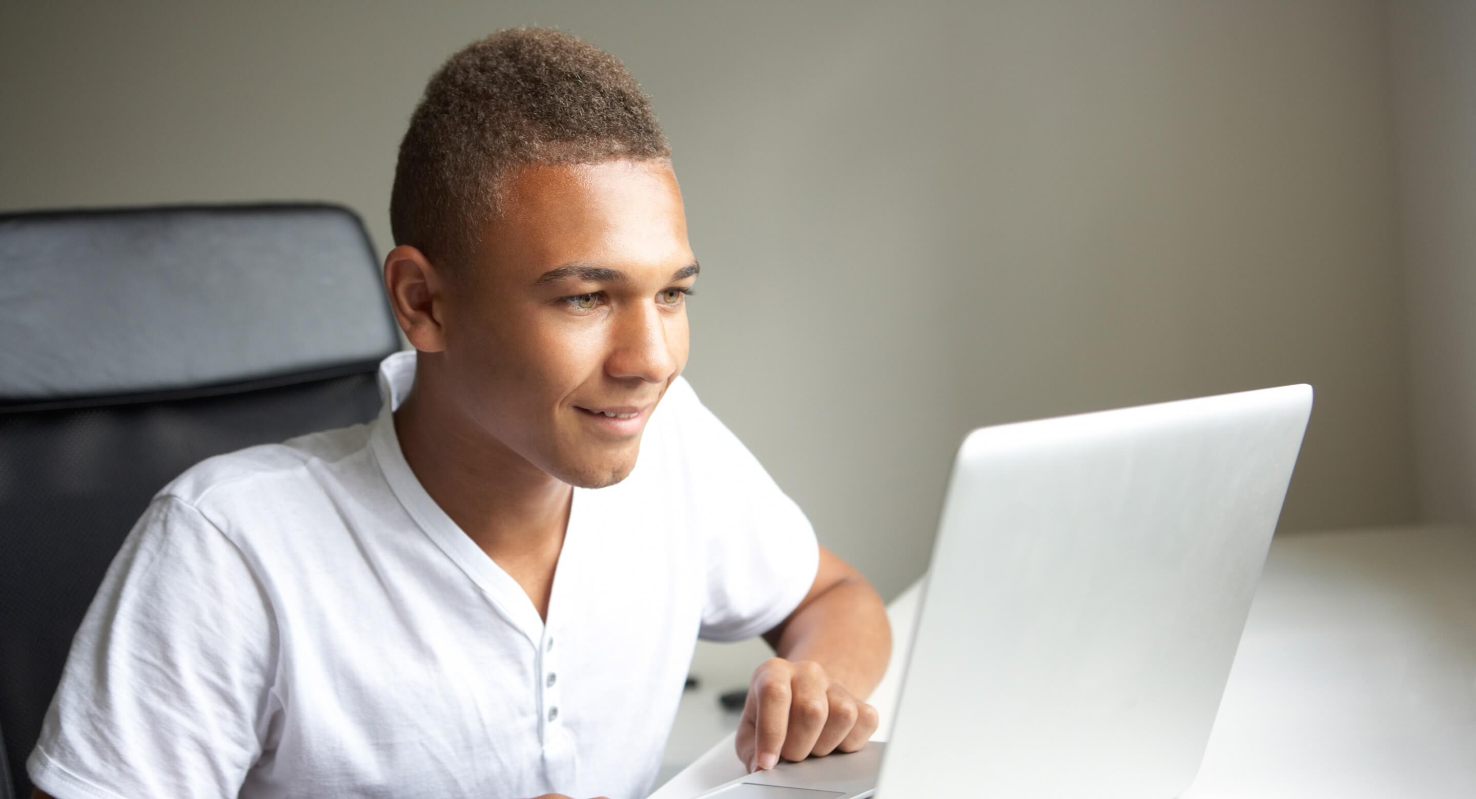 Teen male using laptop