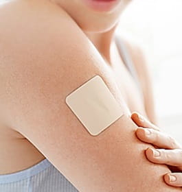 A nicotine patch on someone's arm.