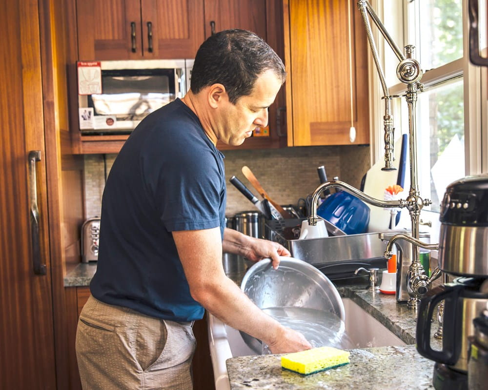 man washing dishes