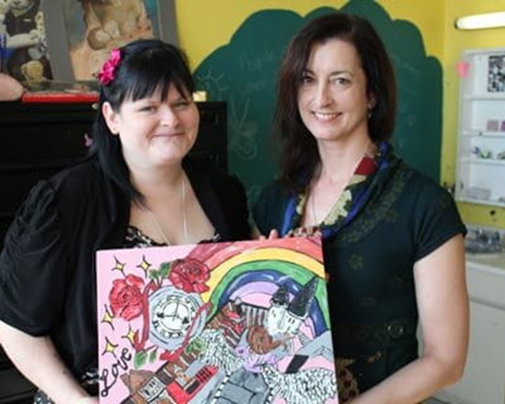 Valynn proudly displays a painting she made after leaving CAMH with her Recreational therapist.