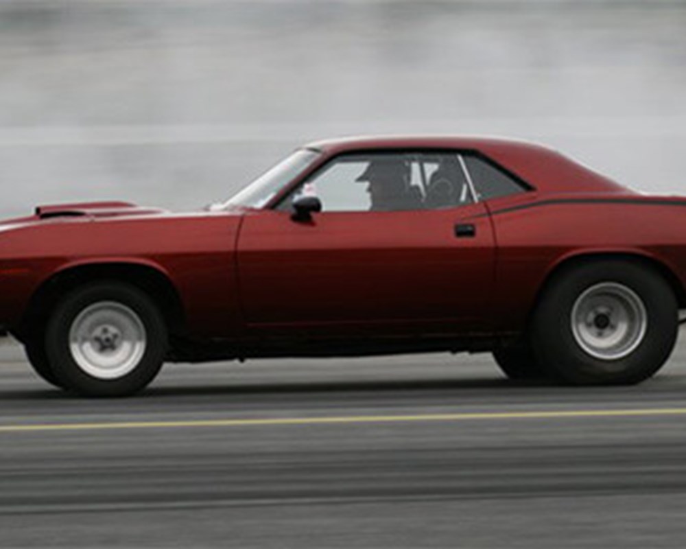 A red car racing through the streets.