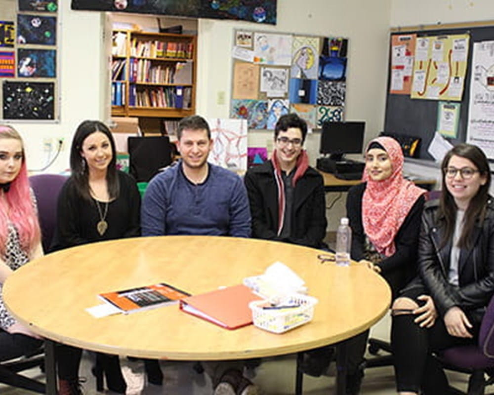 A diverse group of students sitting around a round table.