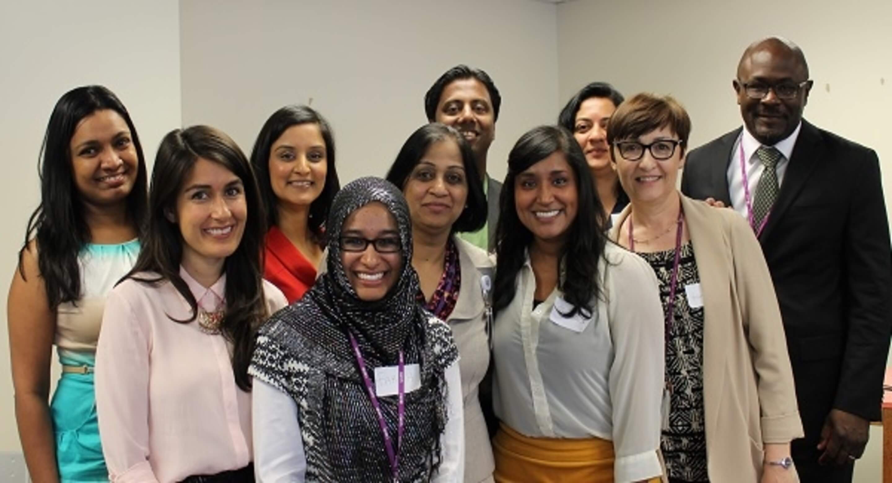 A diverse group of individuals smiling. 