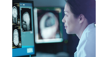 Asian female scientist looks at brain image