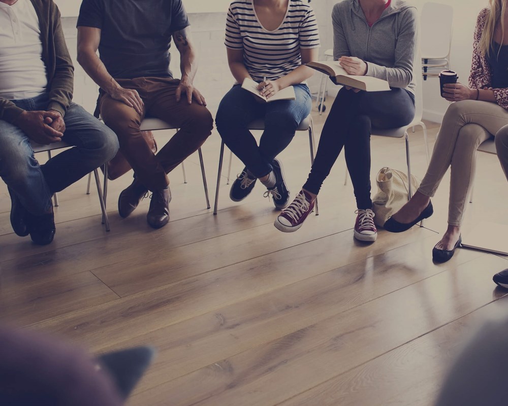 People sitting in a semi-circle with only their legs visible