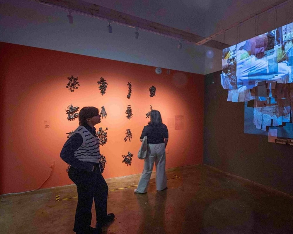People viewing different art installations at the 2025 Being Scene exhibit presented by Workman Arts