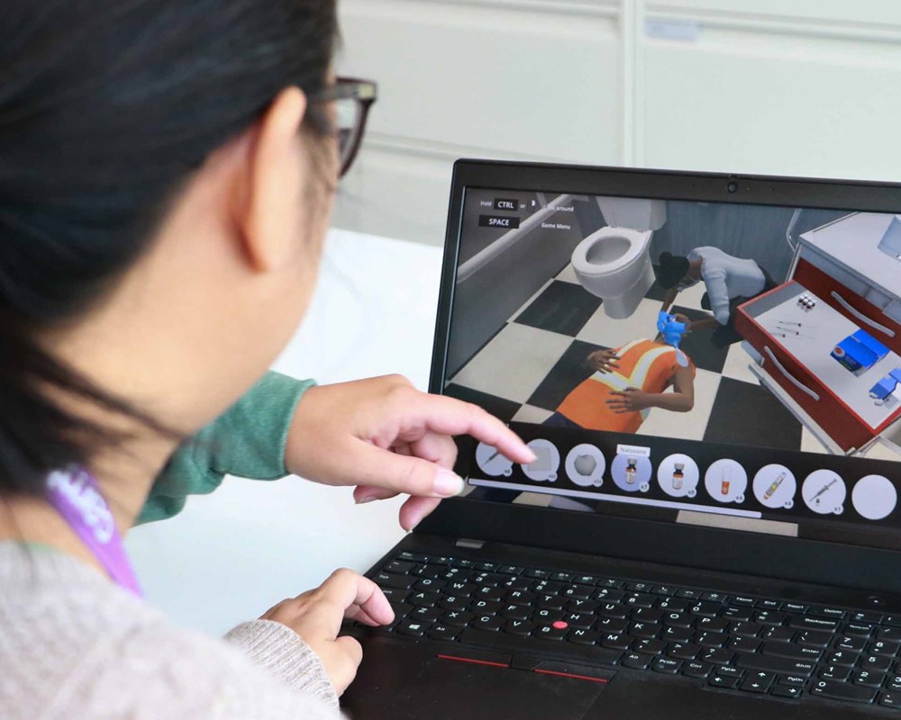 Person on a laptop going through a virtual reality training simulation