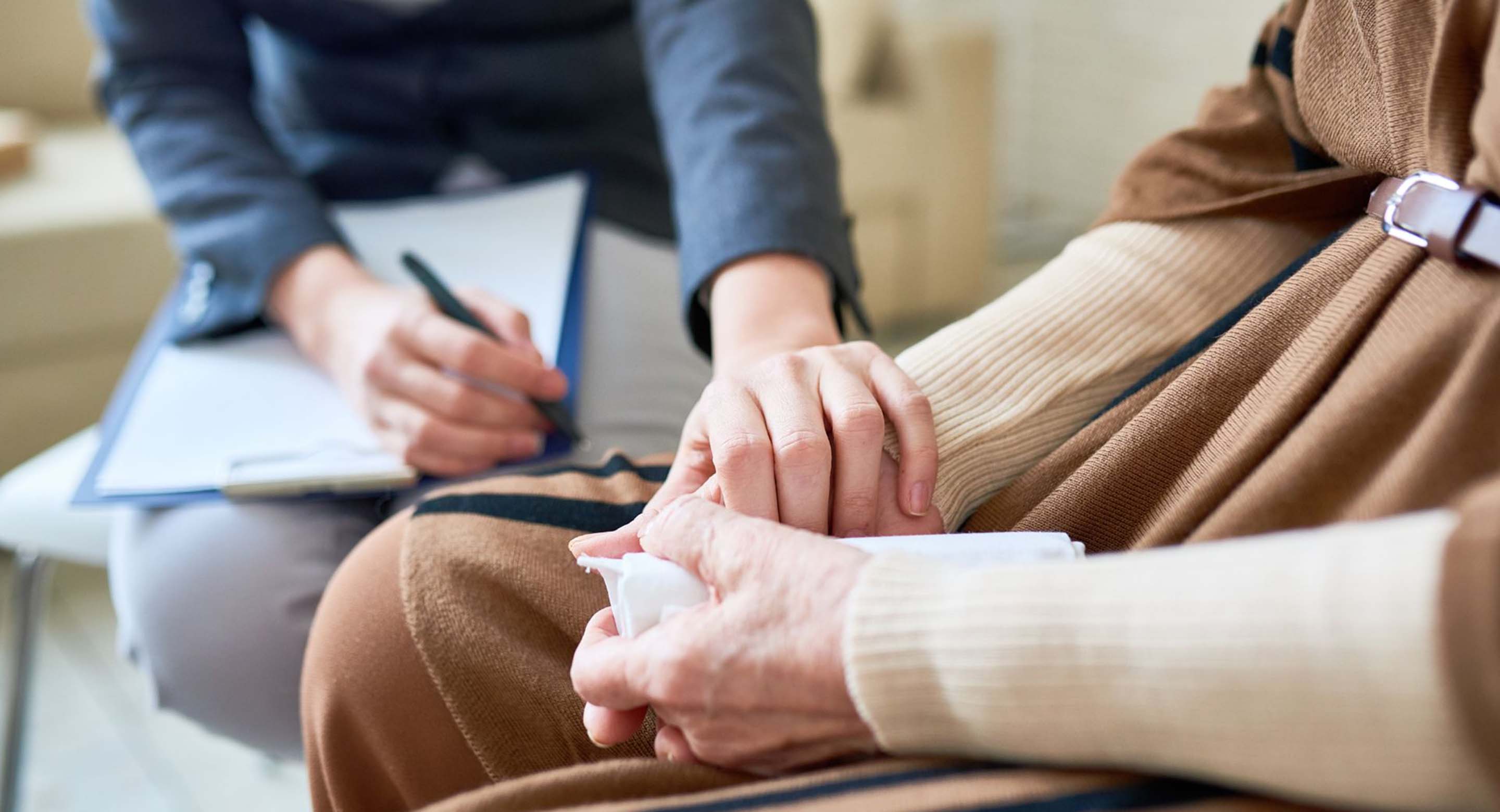 One hand holding another