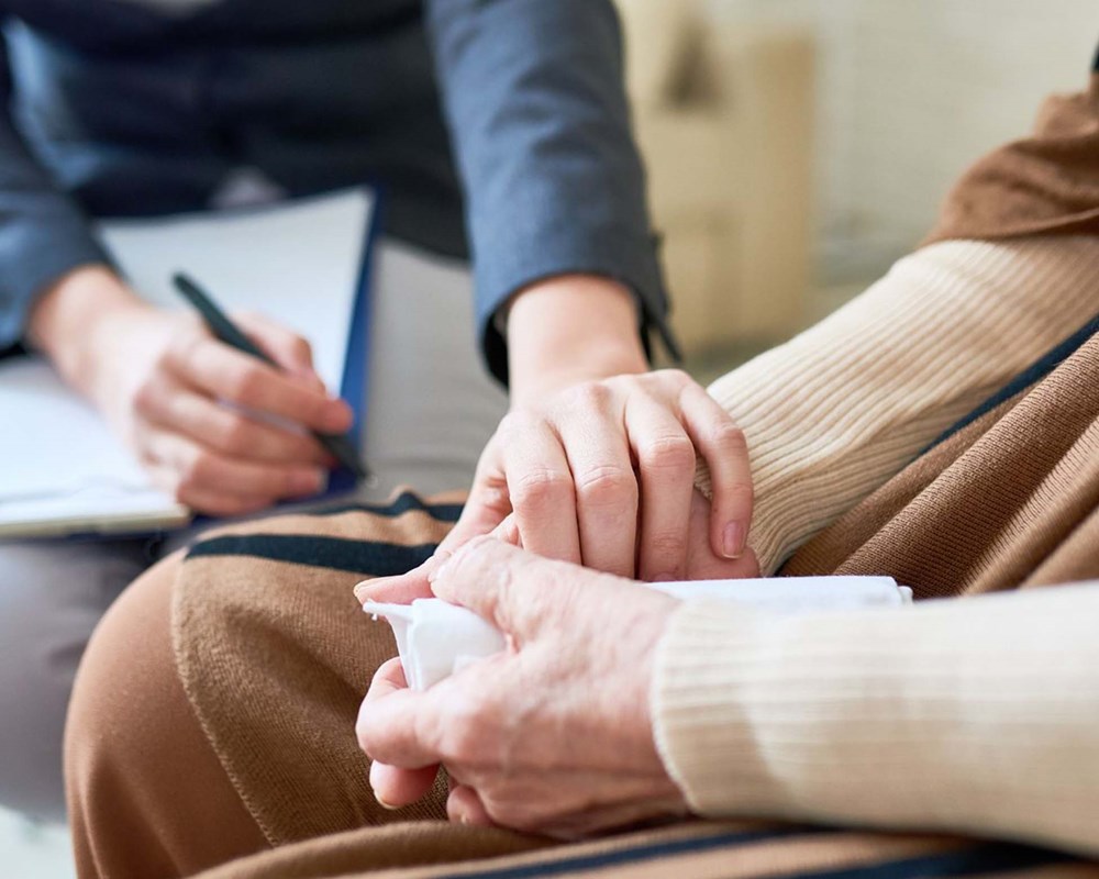 One hand holding another