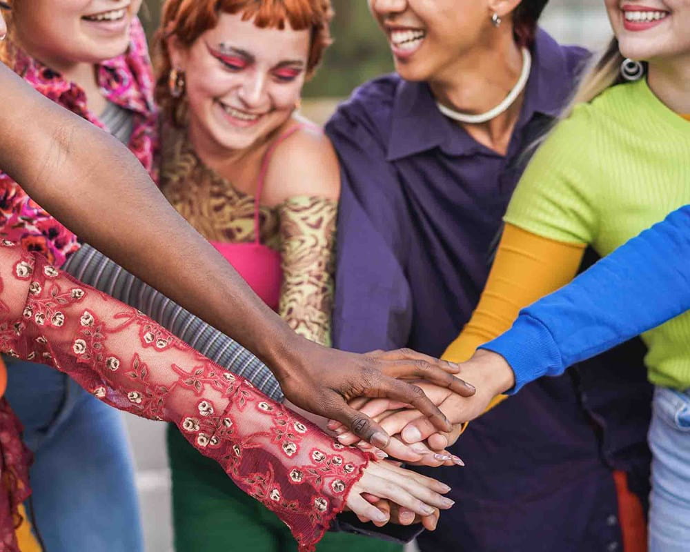 Group of youth putting their hands together