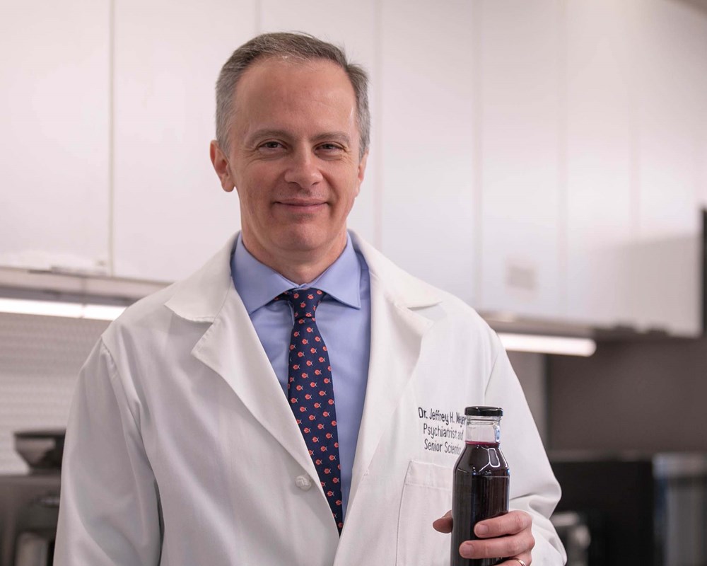 Dr. Jeff Meyer holding up his nutraceutical product