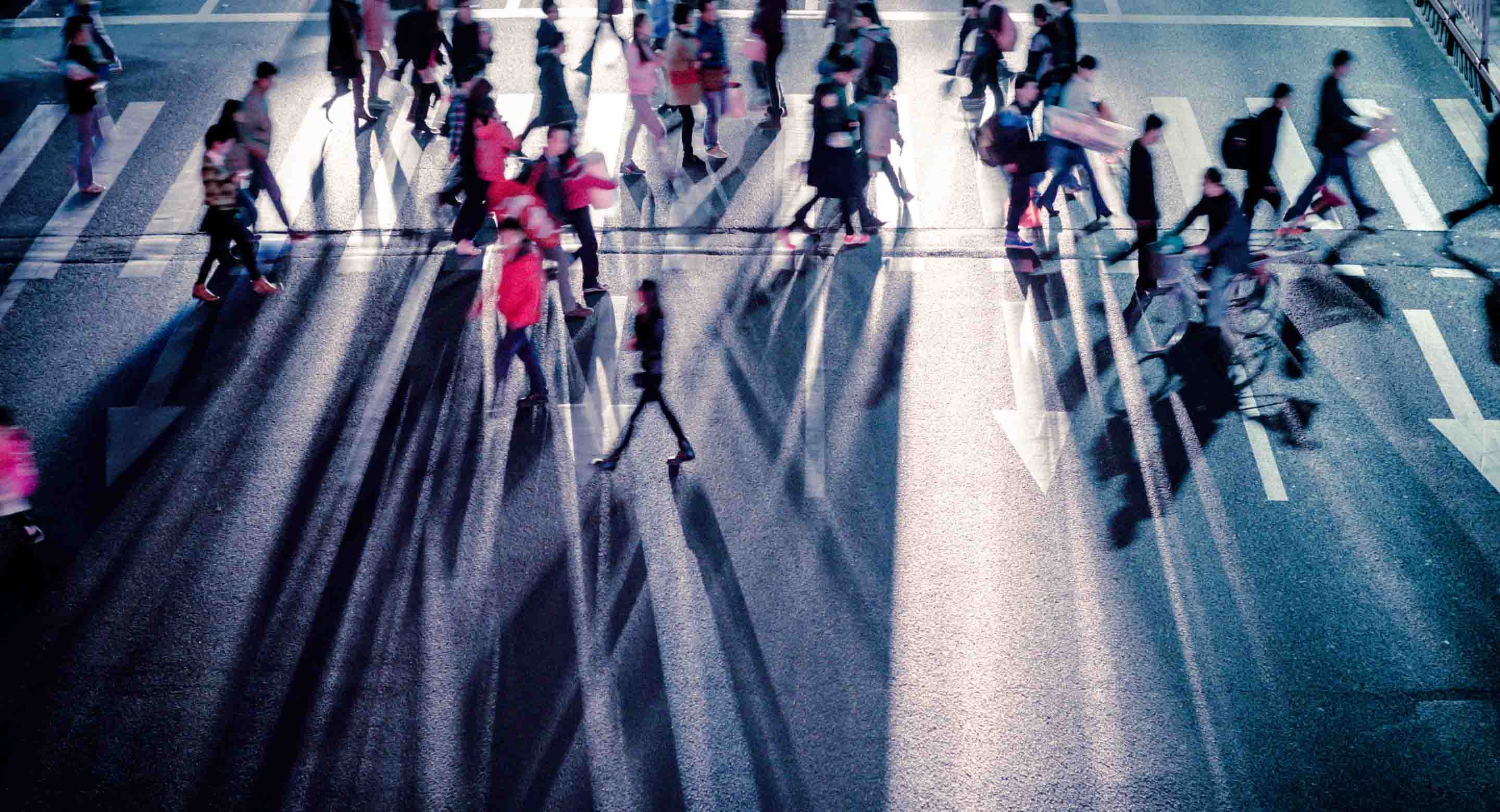 Pedestrians walking across busy street