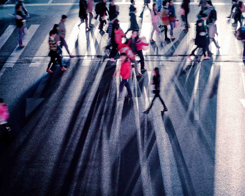 Pedestrians walking across busy street
