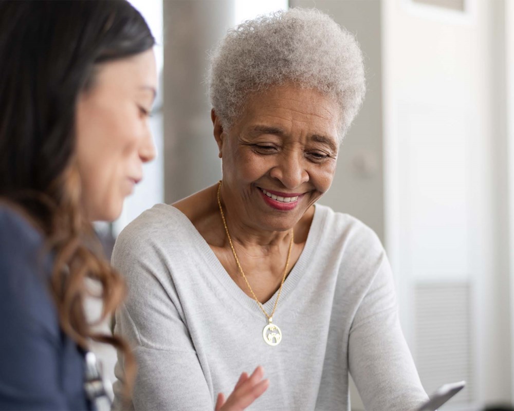 two women looking at a phone or tablet