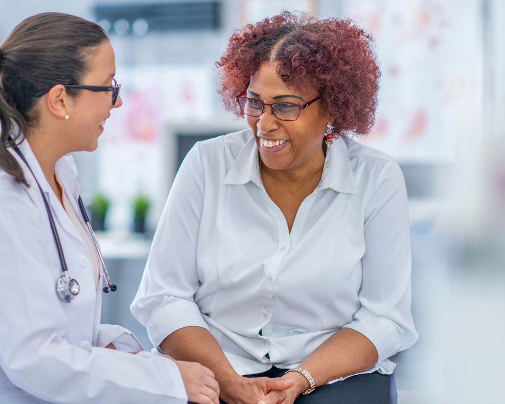 A doctor speaking to her patient