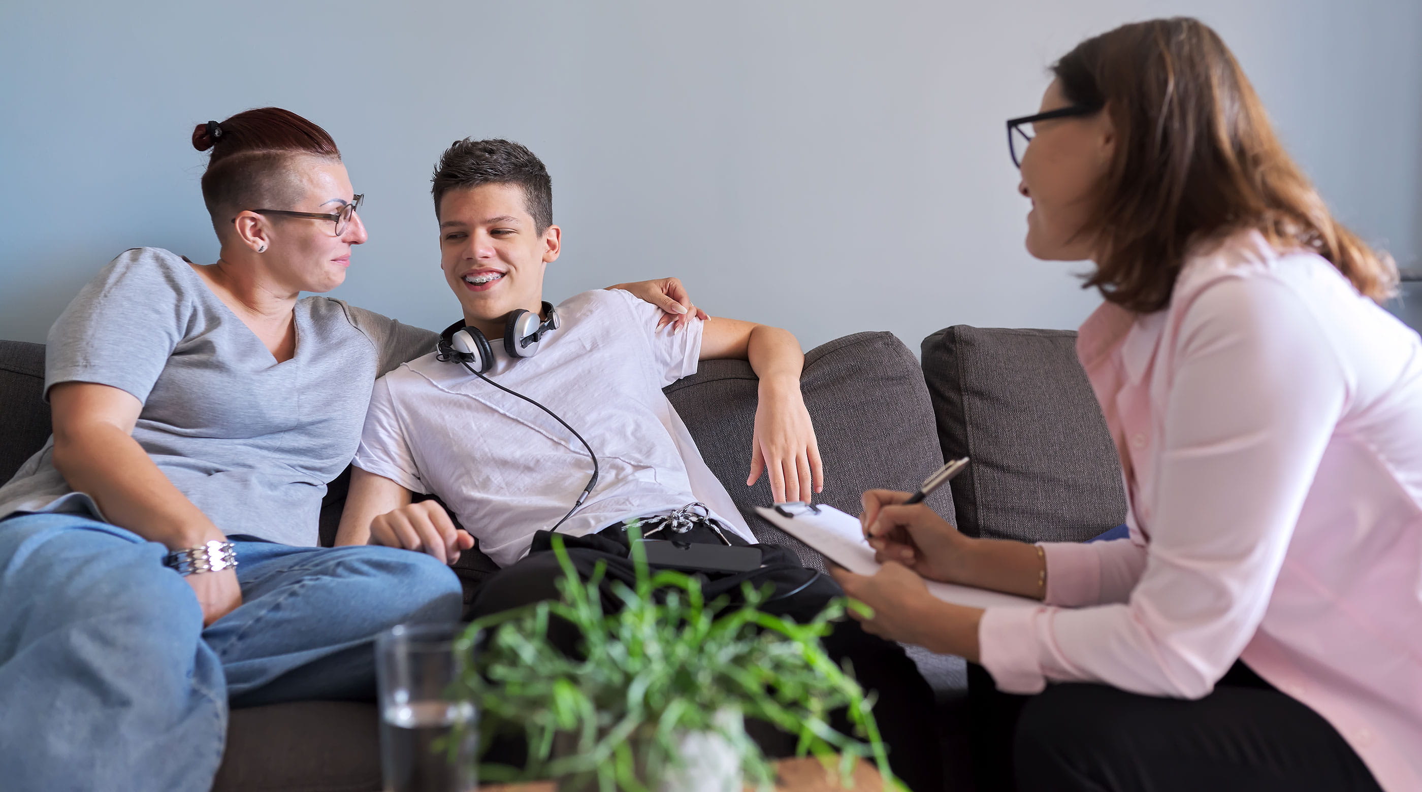 Mother and teenage son meeting with social worker